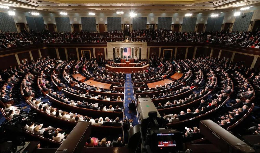 Color Photo: View from the cheap seats at the back of the U.S. House of Representatives showing a full house during a State of the Union Address.

📸: Brookings
