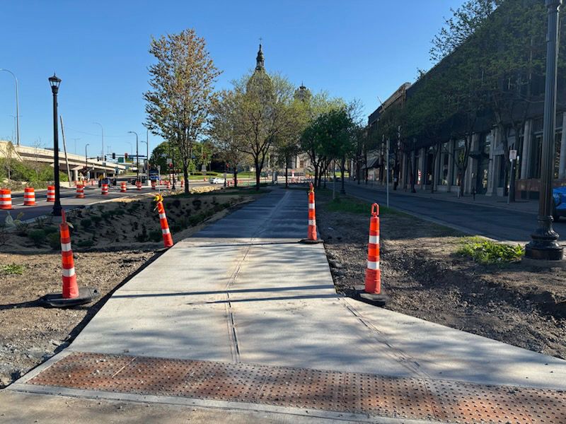 A photo of the "After" condition of the Hennepin-Loring connection, with the concrete trail poured and GSI planted.