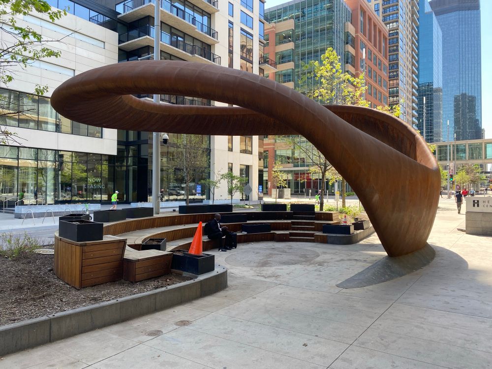 A photo of the Nimbus sculpture outside of the Hennepin Central Library without fencing surrounding the seating area.