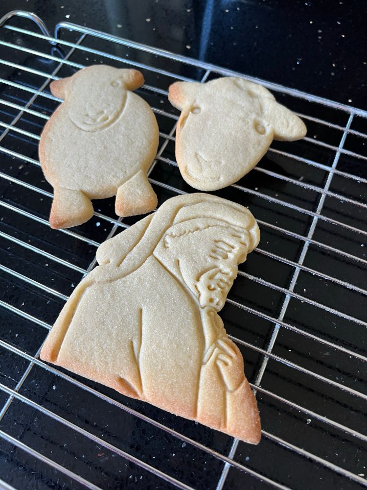 Three biscuits: one of a sheep, one of a sheep’s face, the third a cut out of Chaucer 