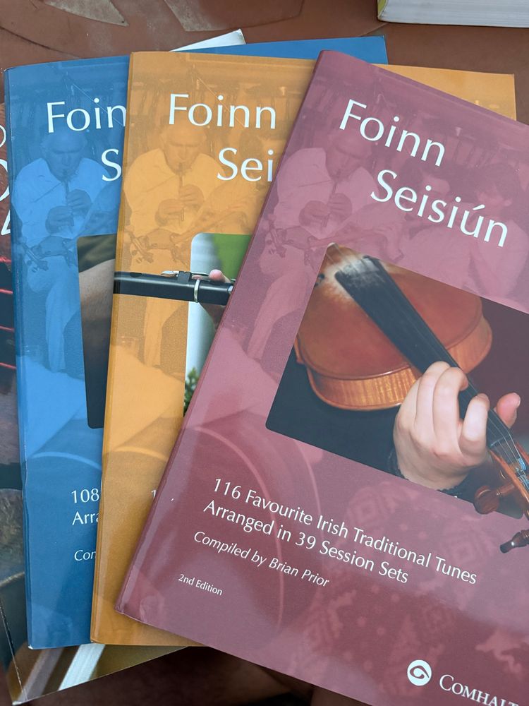 Four Foinn Seisiún books showing traditional Irish instruments on the covers (the seisiún I go to is working through book 1, of which I’ve memorized about a dozen tunes)