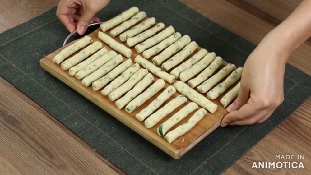 a cutting board with sticks on it that says made in animotica on the bottom