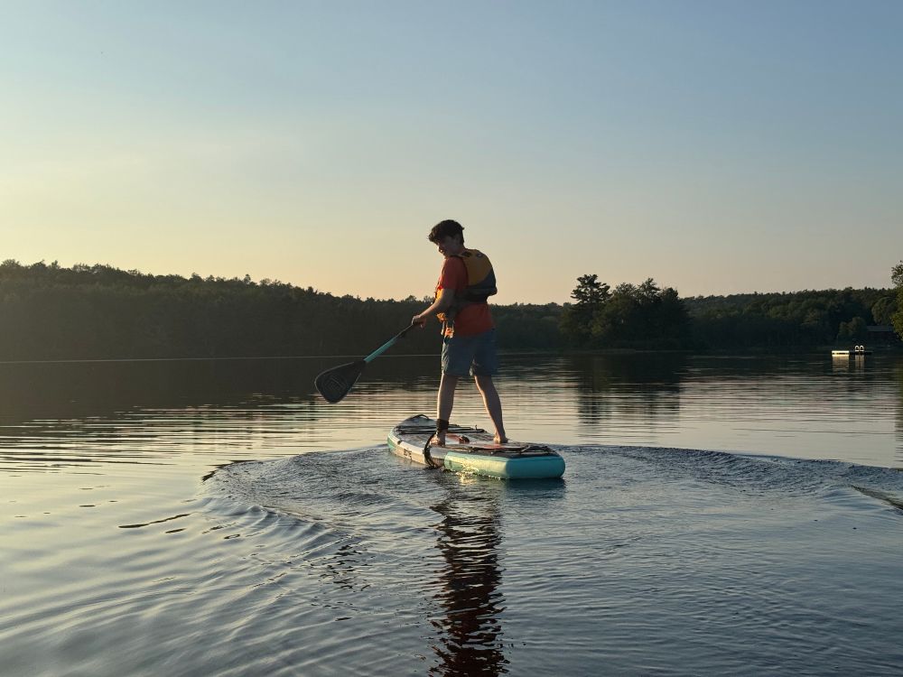 image of my niece on a paddleboard at Lake desolation NY