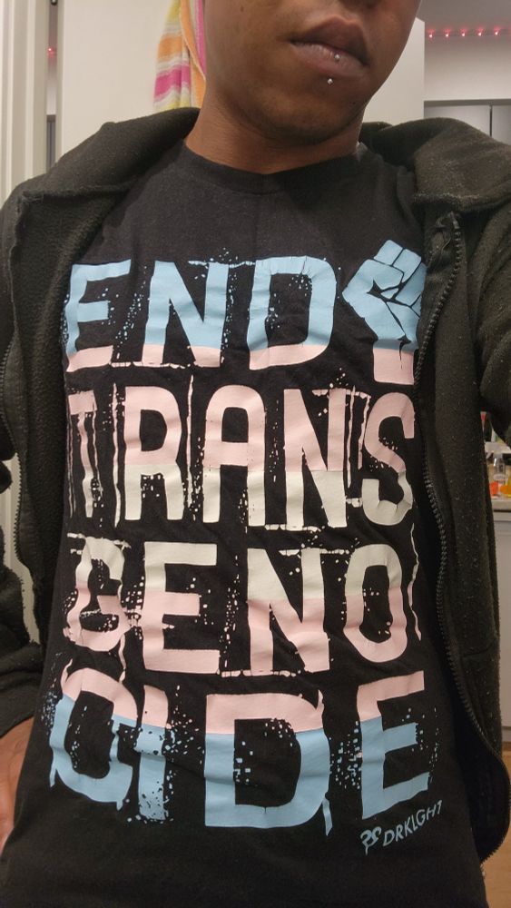 Indigo wearing an end trans genocide shirt from DRKLGHT.com