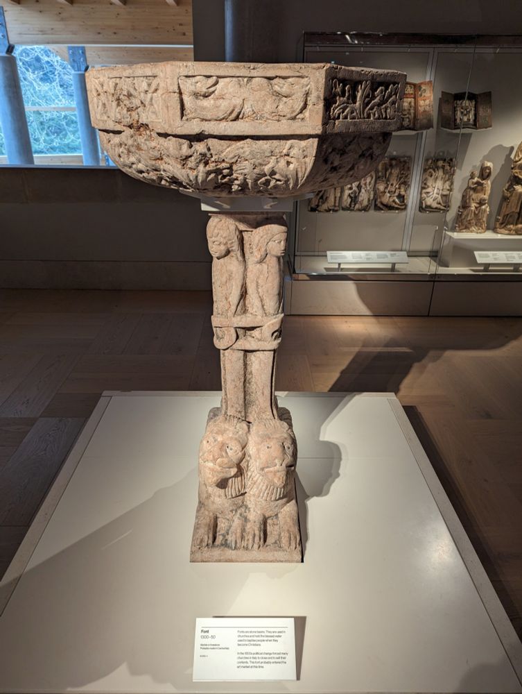 Italian font either limestone of marble with lions at the base and people on the stand, ornately carved top bowl