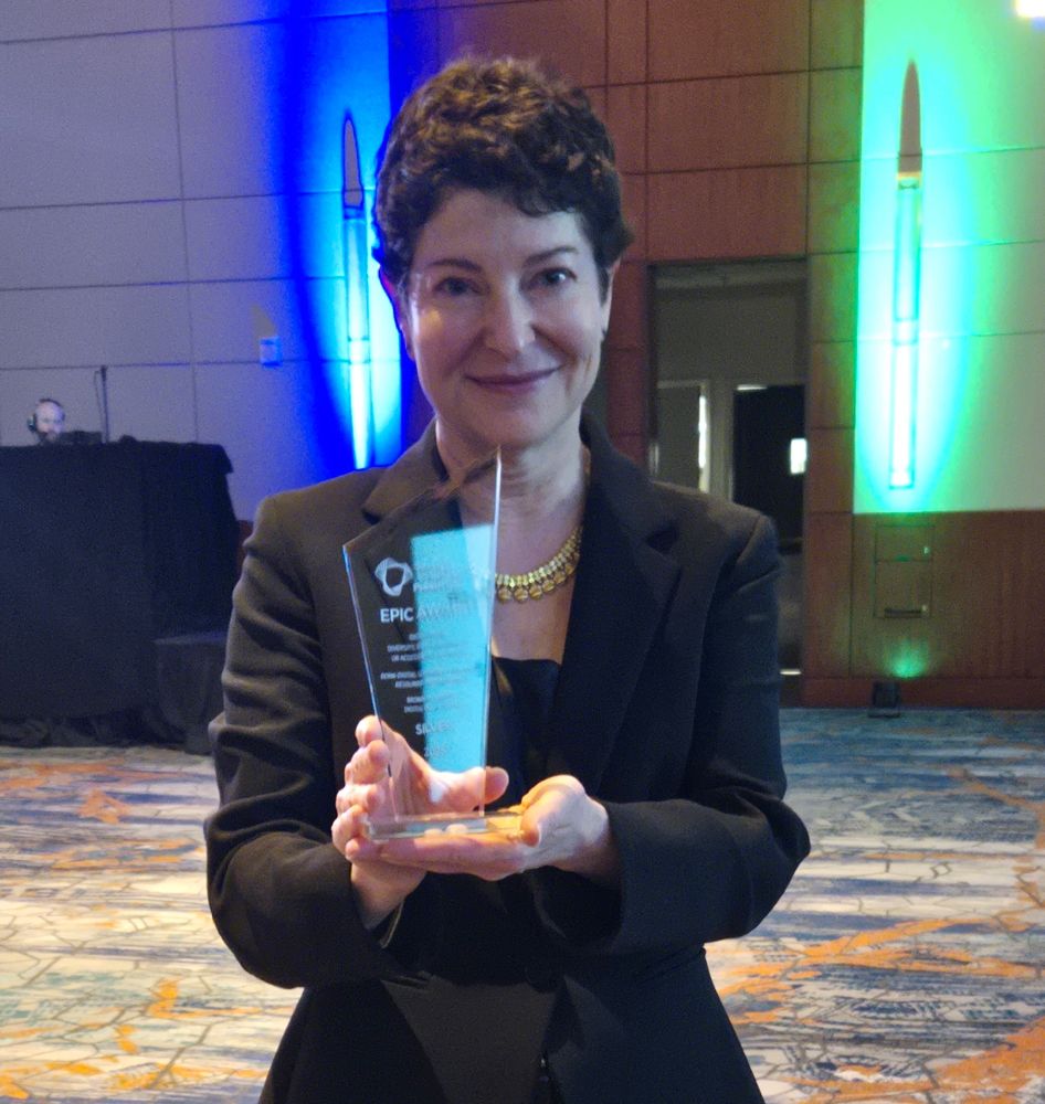 BUDP director Allison Levy holds EPIC Award.