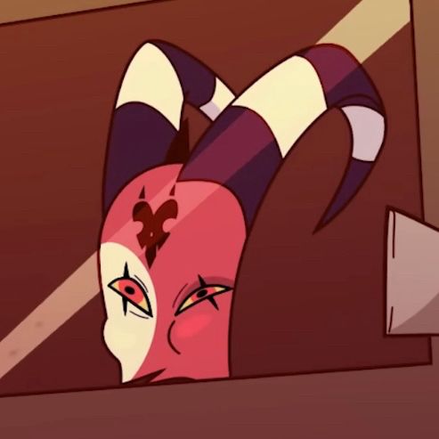 A screenshot of Blitzo from Helluva Boss – an imp demon with red skin and a white half-moon scar on the right side of his face and a black marking on his forehead with black and white-striped horns that curve backwards – shown from the chin up behind the window of a car. He’s drunk as a skunk and wearing a dazed expression, with his eyes narrowed as he squints through the glass. 