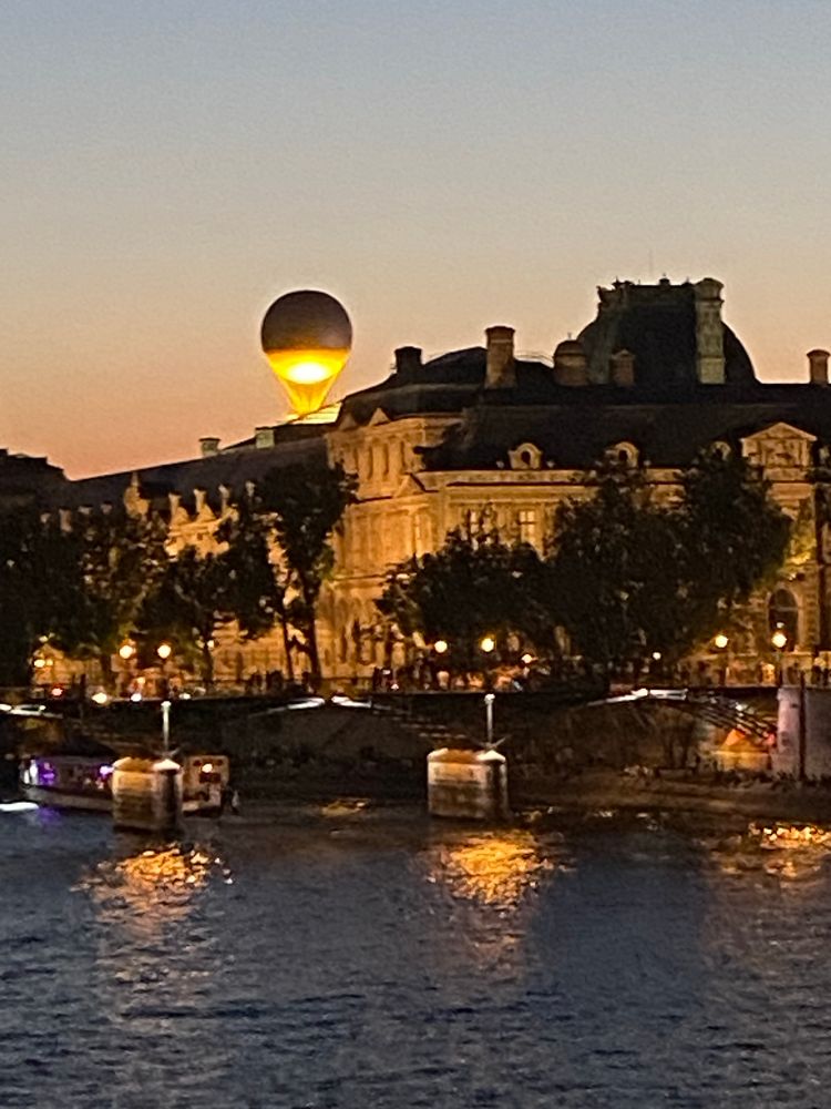 The Olympic balloon floating above the Tuileries viewed from Pont Neuf