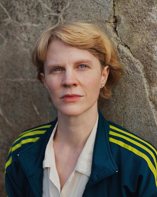 Image of a Hannah Lutz, a woman with short blonde hair and blue eyes.