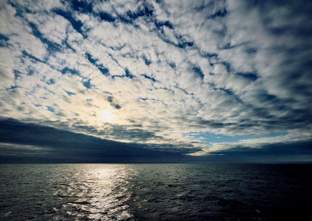 Photo of clouds at sunrise over the sea