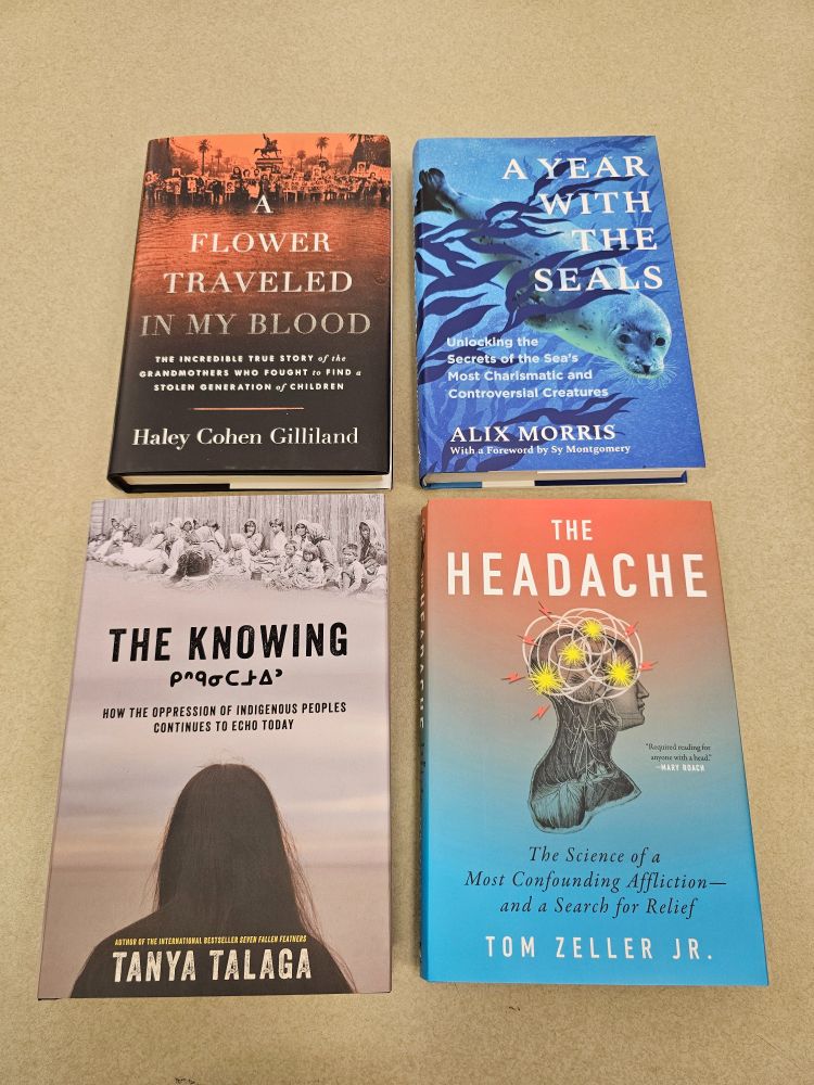 Four nonfiction books on a table, clockwise from top left: A Flower Traveled in My Blood by Haley Cohen Gilliland, A Year with the Seals by Alix Morris, The Headache by Tom Zeller Jr., and The Knowing by Tanya Talaga.