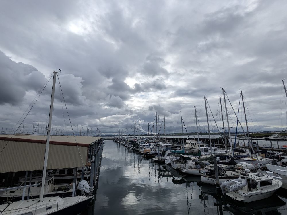 A view of a marina under a very thick blanket of dark clouds covering the whole skies