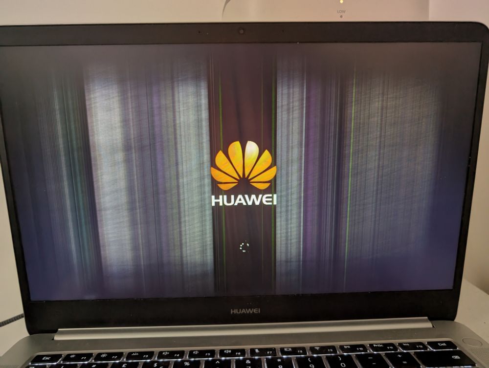 Photo of my laptop screen, with white LCD fail lines running vertically across it and the Huawei logo in the center.