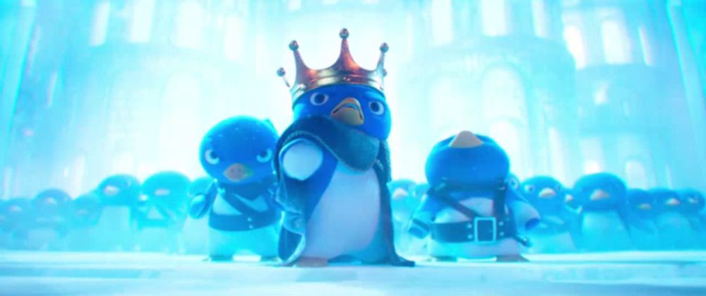 a penguin wearing a crown stands in front of a crowd of other penguins