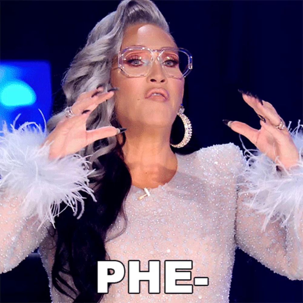 a woman with glasses and feathered sleeves says phe-