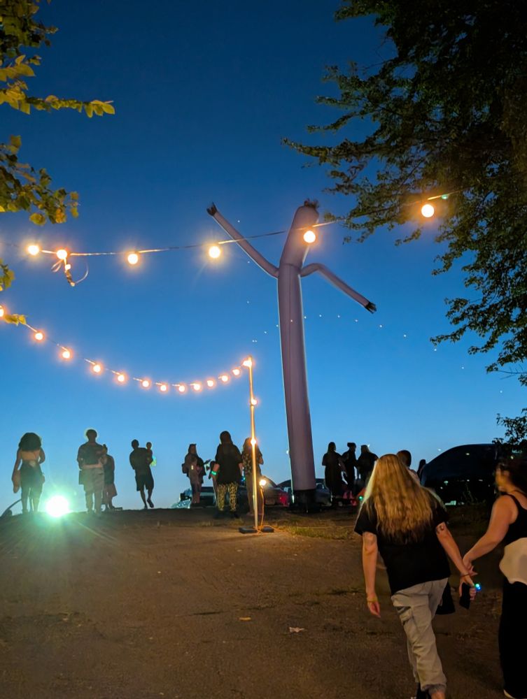An inflatable tube man at dusk 