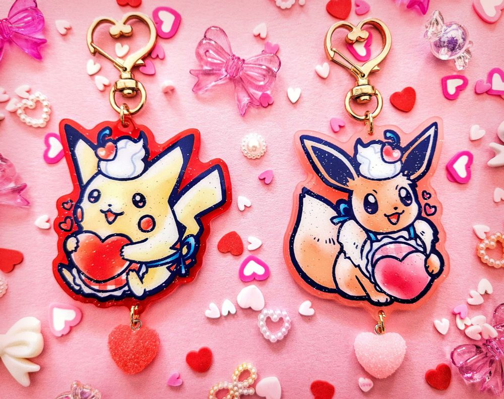 A set of two keychains featuring a Valentine's Day themed Pikachu and Eevee.
