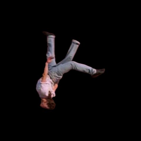A still from an old SNL sketch of a person doing a backflip wearing 3 legged jeans. 
