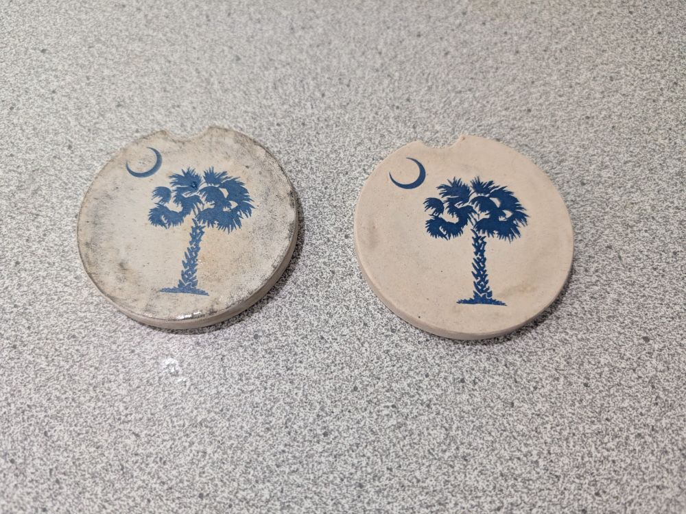 Before and after of coaster cleaning:

On the left, a filthy, scuffed stone coaster with the South Carolina palmetto moon emblem. On the right, an identical but significantly cleaner and shinier coaster.