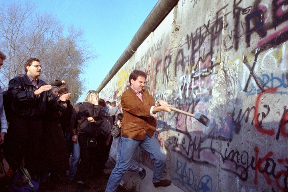 The Berlin Wall being torn down. 