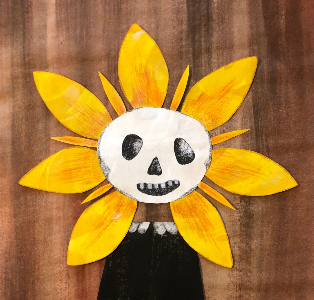A smiling skeleton has a corona of bright yellow sunflower petals around its head.