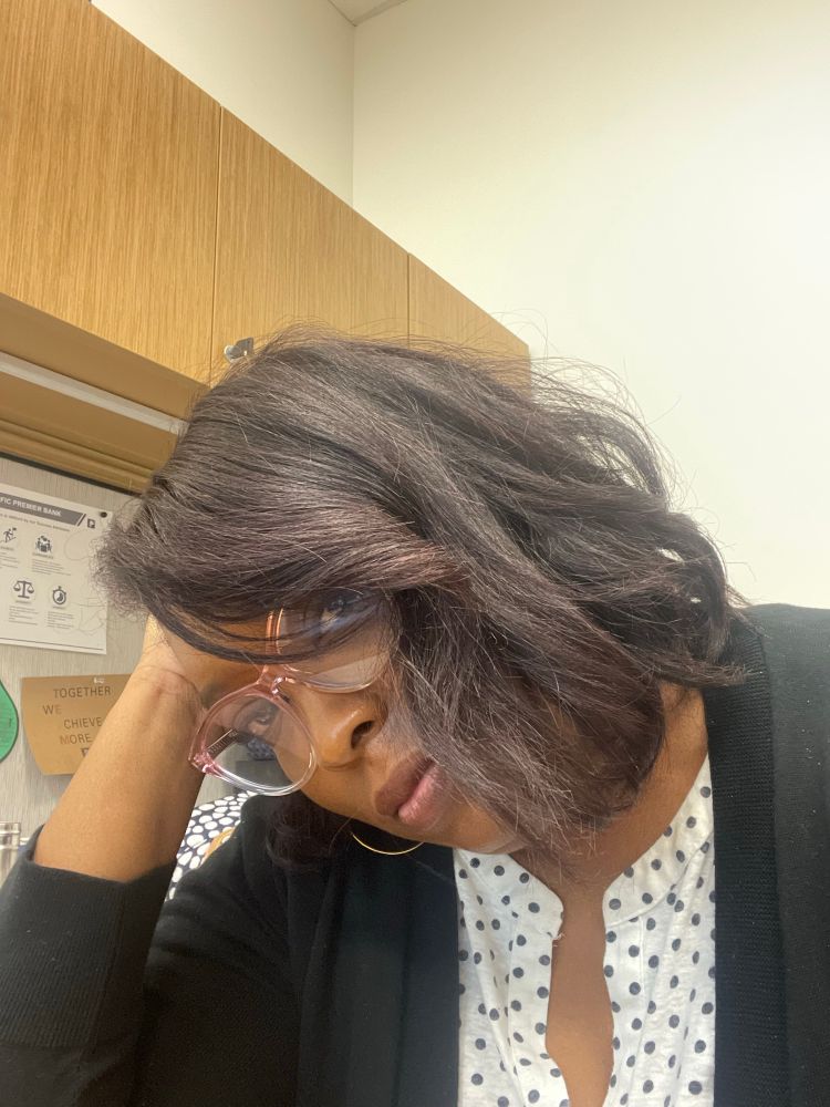 Black woman wearing glasses and a black sweater