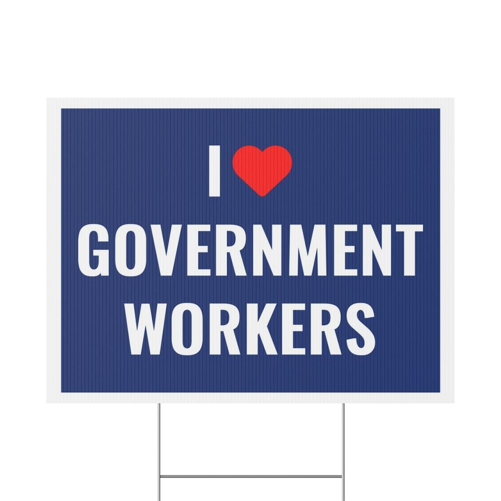 Blue sign with white text saying I Love Government Workers. The word love is substituted with a red heart.