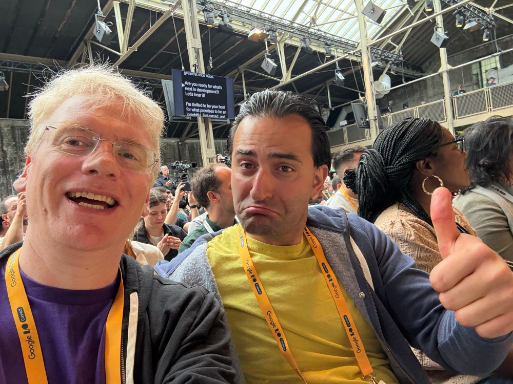 Chris and Majid with audience in background