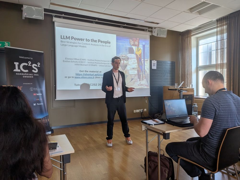 Étienne standing in front of their title slide on "LLM Power to the People"