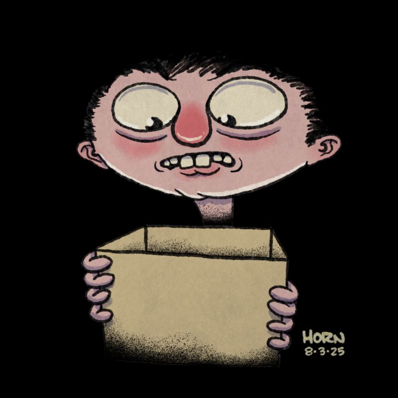 A guy looks nervously into the cardboard box he is holding.