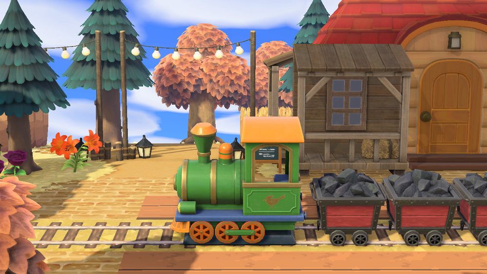 acnh fake train station :green train, coal minecarts, trees, string lights, villagers house, fake storefronts attached to villagers house, fake brick, fake train tracks, fake wooden boards, flowers