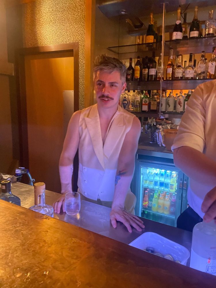Me behind the bar having had enough, in just my white waistcoat and trousers 