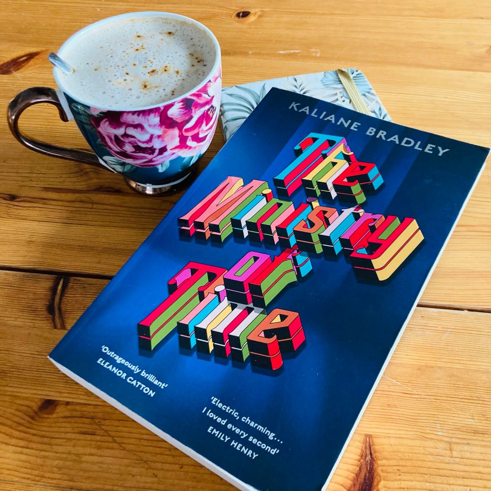 Paperback of the book ‘The Ministry of Time’ with a cup of coffee. 
