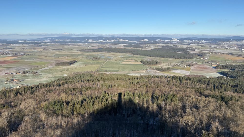 Image taken from a high vantage point over a rural landscape with a shadow visible in the front of the pic. More can't be told here. 