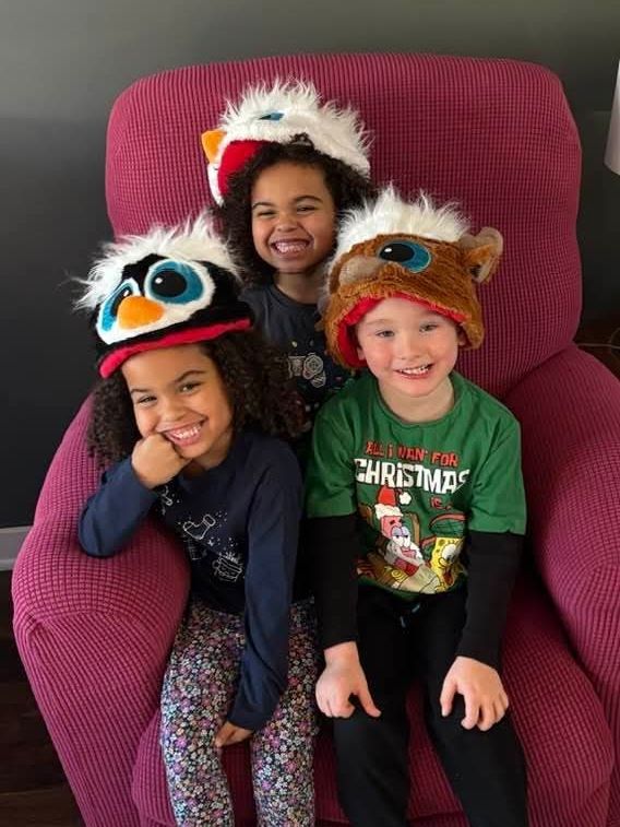 3 cousins with Christmas hats on
