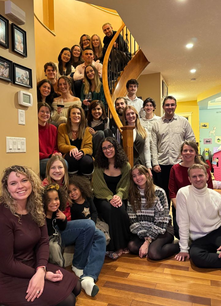 group photo of a wonderfully talented group of scientists + their friends/partners on a spiral-ish staircase
