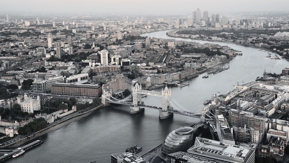 London seen from the air, including the river, Tower Bridge and Canary Wharf in the background.