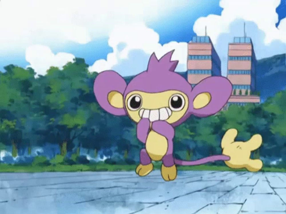 a purple and yellow cartoon monkey is standing on a sidewalk with trees in the background