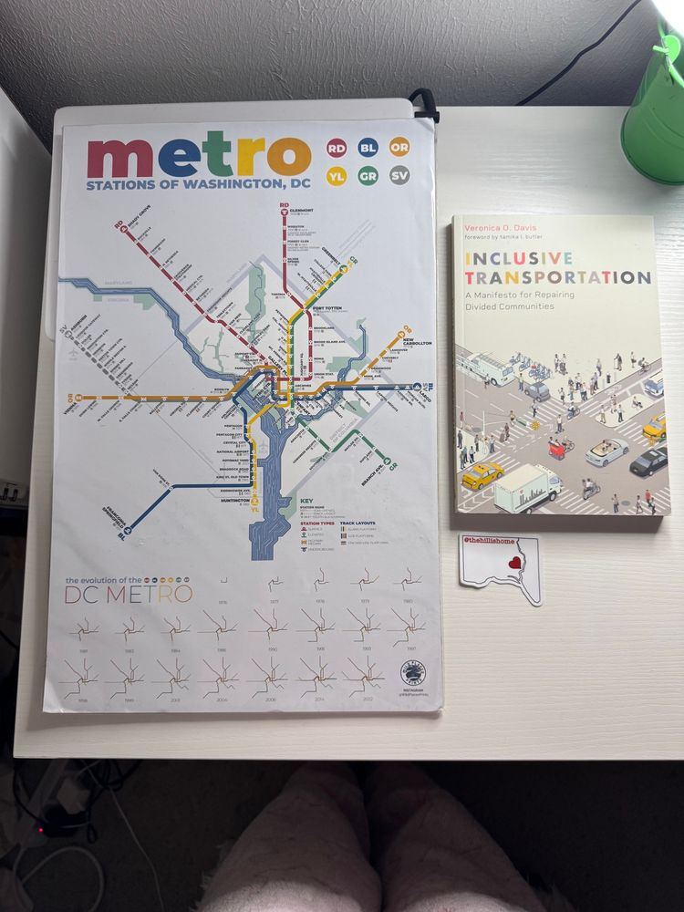 My TranspoBINGO prize featuring my ‘Evolution of The DC Metro’ cardboard map, copy of Veronica O. Davis’ Inclusive Transportation, and Hill Is The Home sticker.