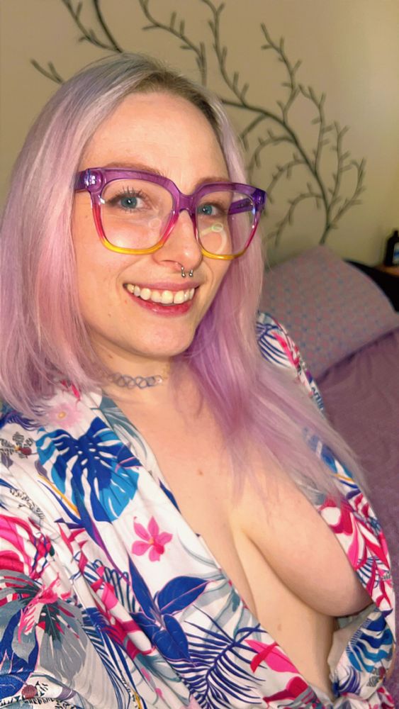Selfie of a pink haired woman in an open robe leaving just enough to the imagination. 
