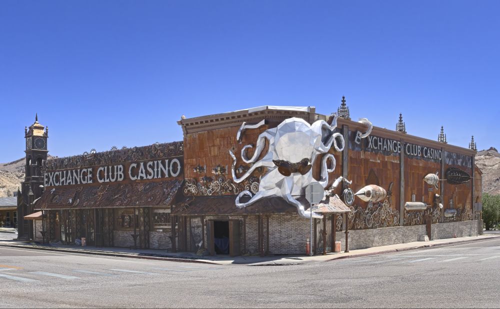 The exterior of the Exchange Club in Beatty NV. The motif is Steam Punk. A well executed collection of gears and machinery. Capped by a a giant octopus crawling down the wall. 