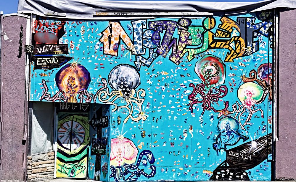 A roadside mural on SW Coast Highway, Newport, OR. Blue background with several squids.