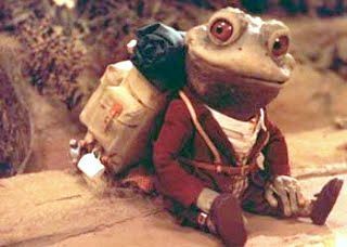 A model of Mr Toad. He is sitting and smiling, likely dreaming up some mad new adventure or composing a self aggrandizing song in his head.