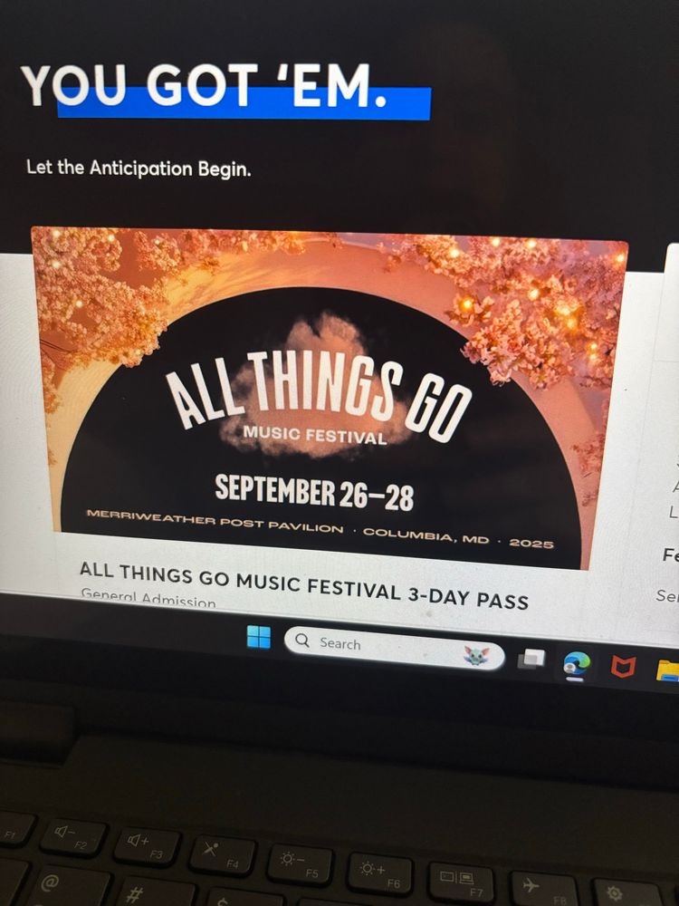 Picture of laptop screen with Ticketmaster page “You Got Em. Let the anticipation begin.” All Things Go Music Festival September 26-28 on a cloudy pink background. With smaller text that says “All Things Go Music Festival 3-Day Pass”