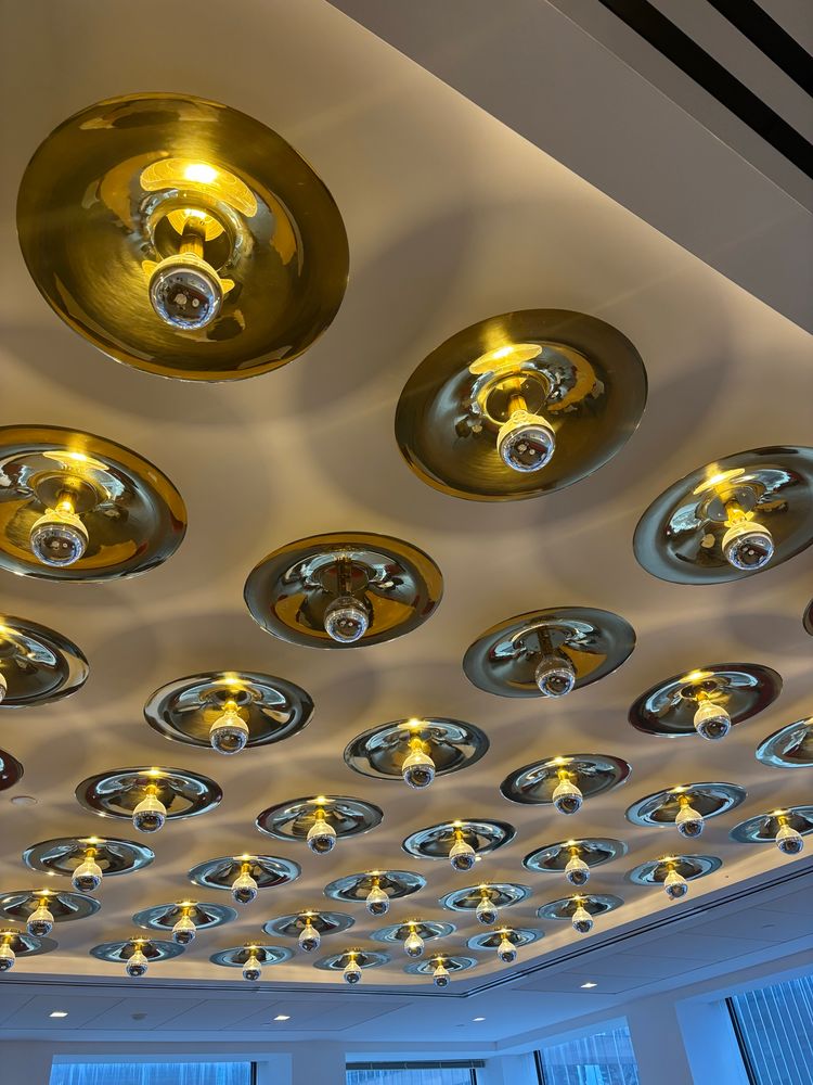 Picture of ceiling with circular silver light fixtures 