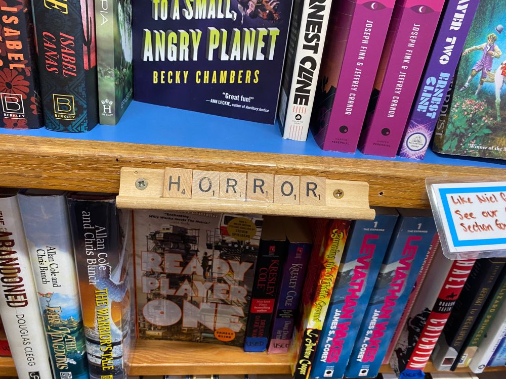 Scrabble tiles spelling “HORROR”