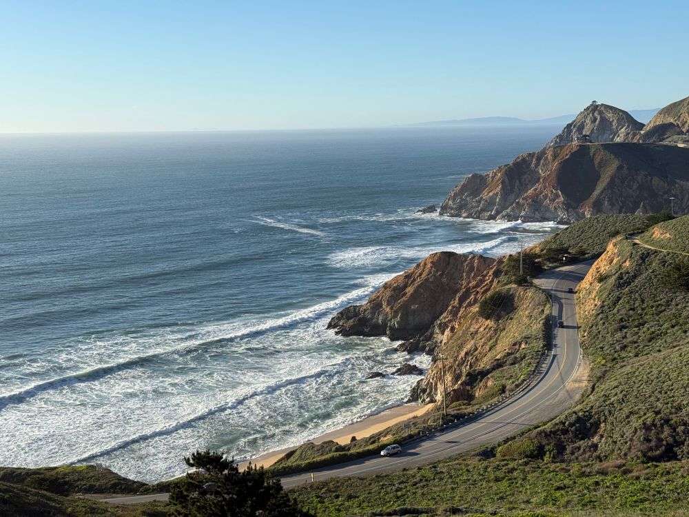 Ocean view with some crashing waves and steep cliffs.