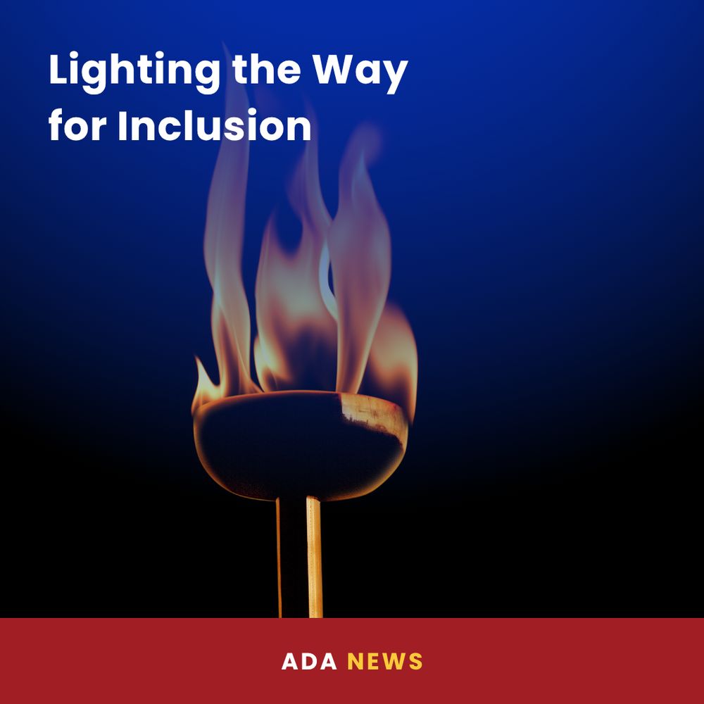 A lit torch burns against a dark background, symbolizing strength and unity. The top left corner features bold white text that reads, “Lighting the Way for Inclusion.” A red banner at the bottom of the image displays “ADA NEWS” in white and yellow text.
