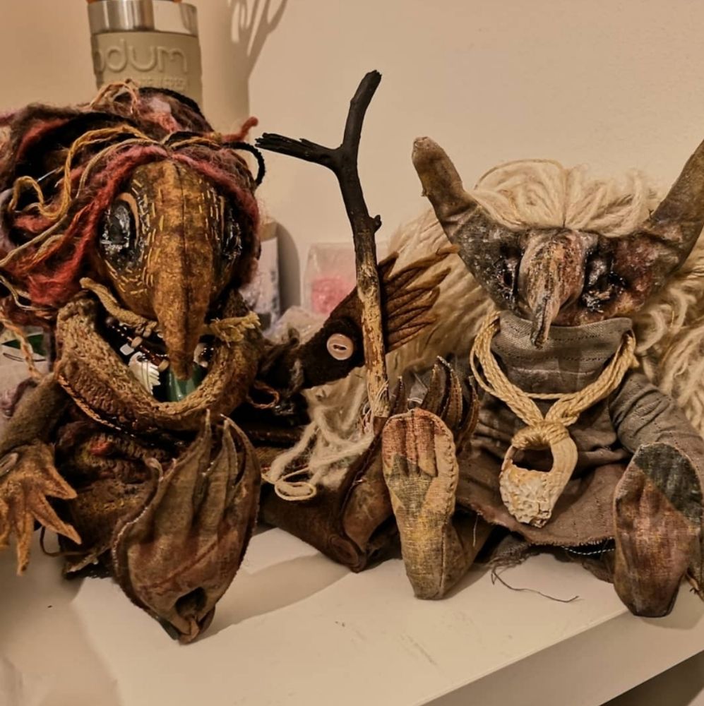 Photo of two handmade textile troll dolls in earthy colours and textures