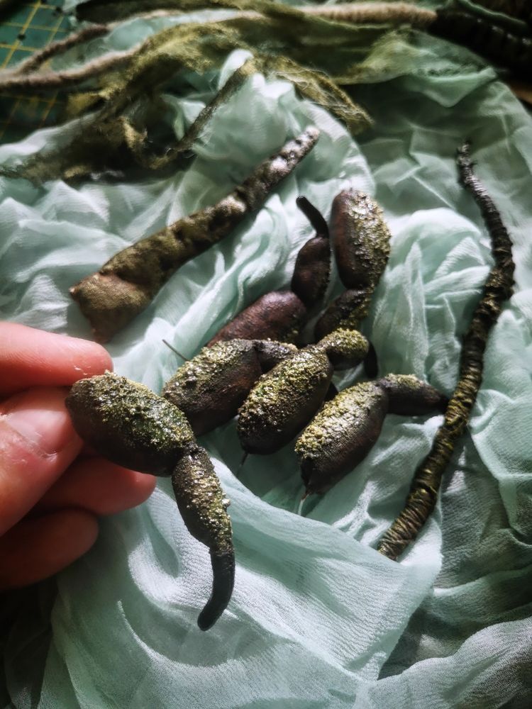 Detail photo of some crustacean-like chitinous legs made from fabric and painted to create texture.